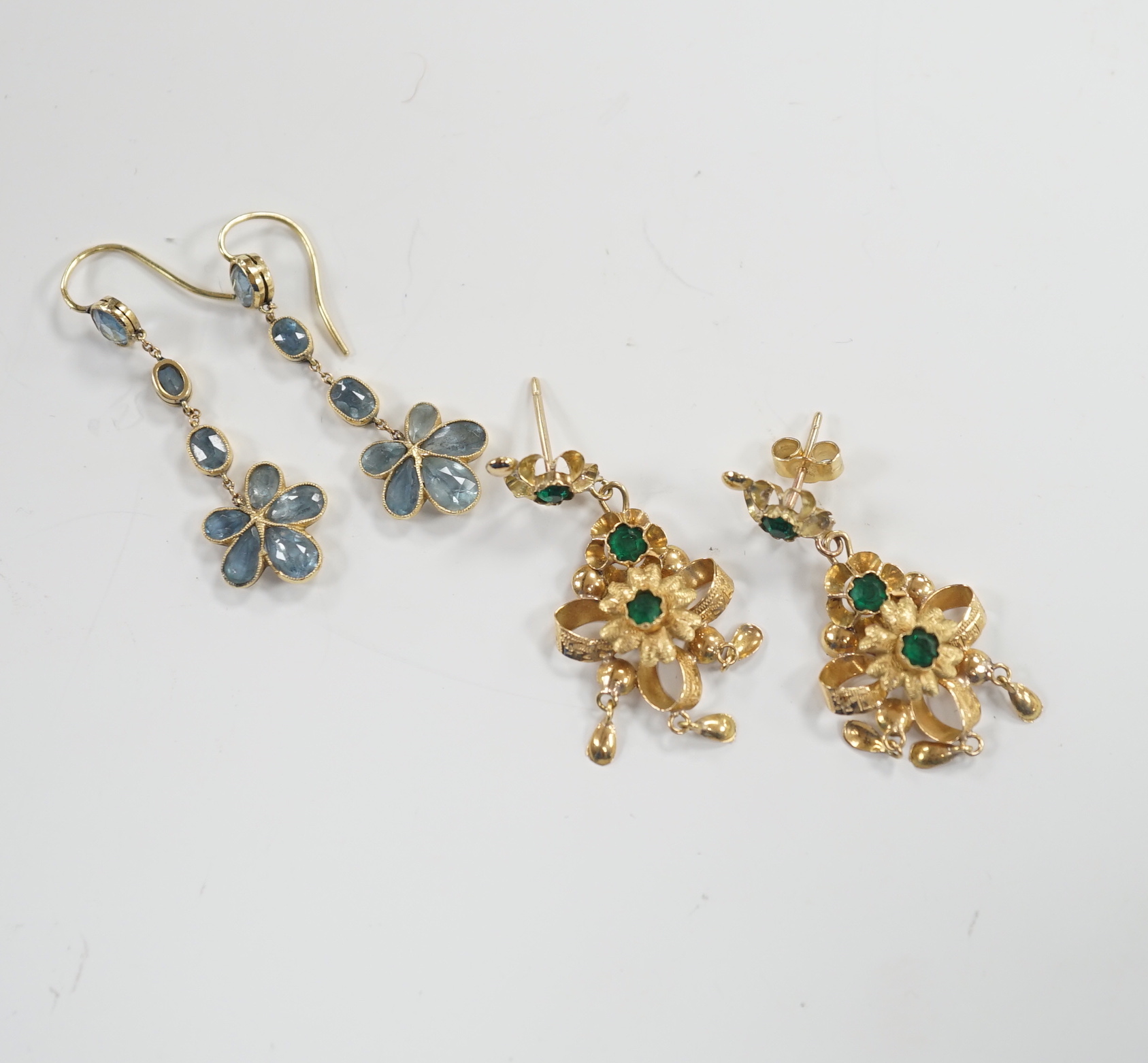 A pair of yellow metal and green paste set drop earrings, 41mm and a pair of yellow metal and aquamarine set cluster drop earrings, gross weight 7.3 grams.